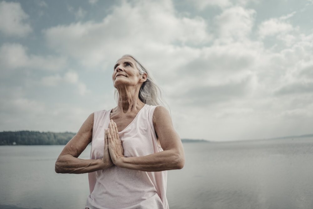 Senior woman meditation at the sea