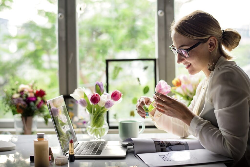 Businesswoman Holding Tulip Flower at Office Desk