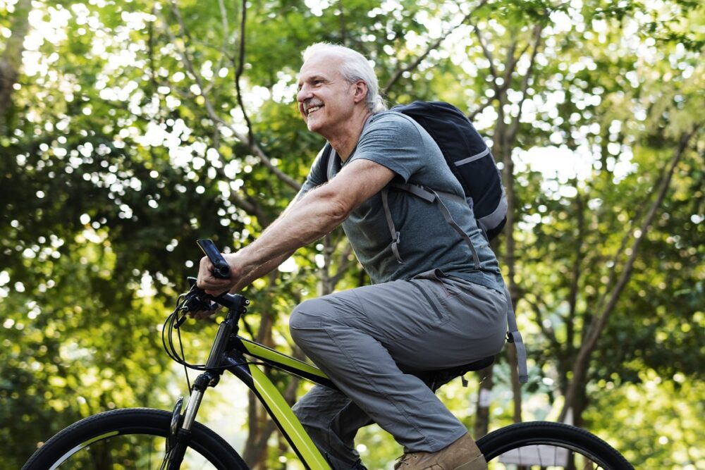 Senior man biking in the park