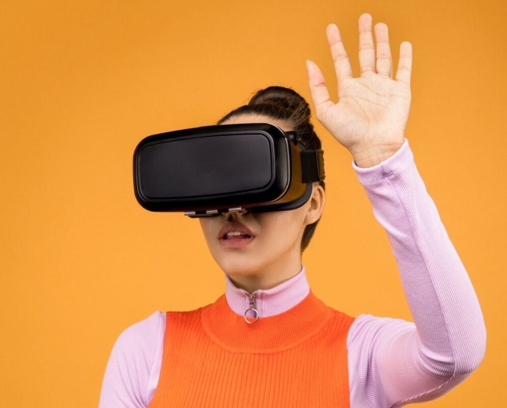 image of a woman wearing a virtual reality relaxation headset on an orange background